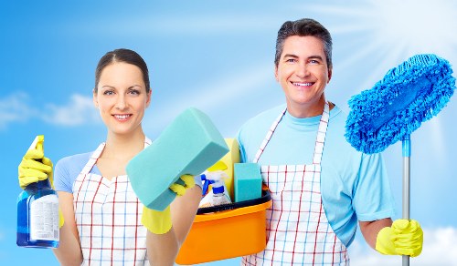 Cleaner working on hard-to-reach windows with a local Earlscourt service